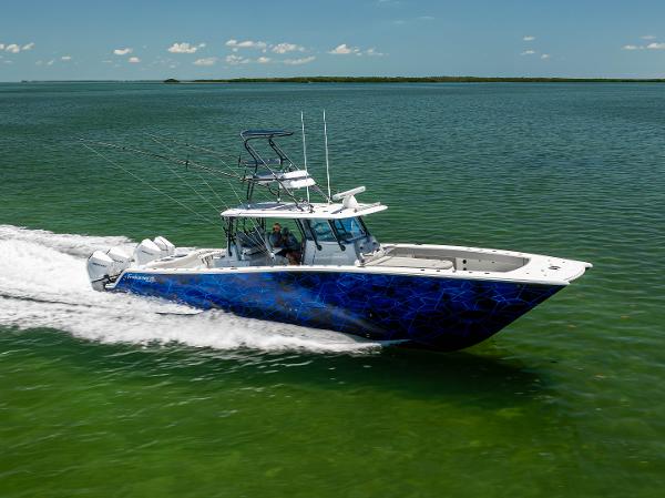Freeman 42 LR 2021 Freeman 42 LR boat cruising on open water, vibrant blue design, clear sky.