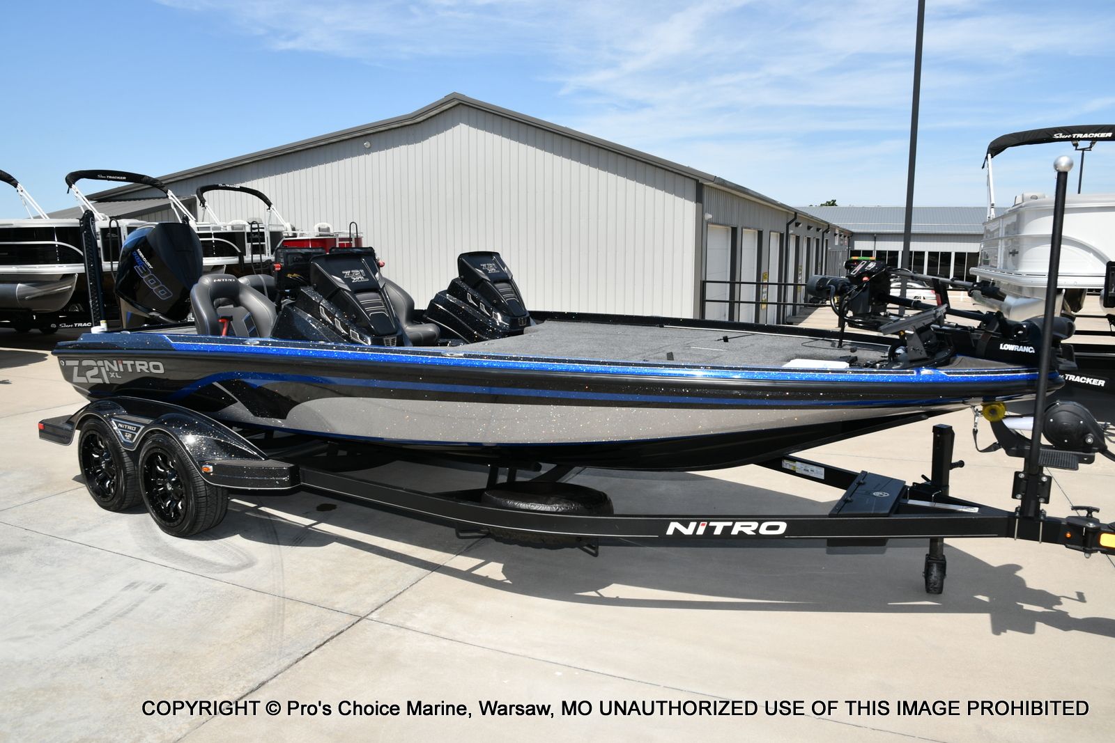 Nitro Z21 XL Pro 2022 Nitro Z21 XL Pro boat on trailer, parked outdoors near a marine facility.
