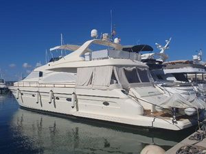 Astondoa 72 GLX Luxury 2002 Astondoa 72 GLX yacht docked in a marina under clear blue skies.