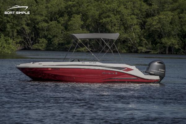 Hurricane SunDeck Sport 205 OB 2023 Hurricane SunDeck Sport 205 OB boat on a calm lake with lush greenery.