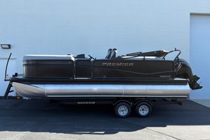 Premier 210 Sunsation RF 2026 Premier 210 Sunsation RF pontoon boat on trailer, parked outdoors.