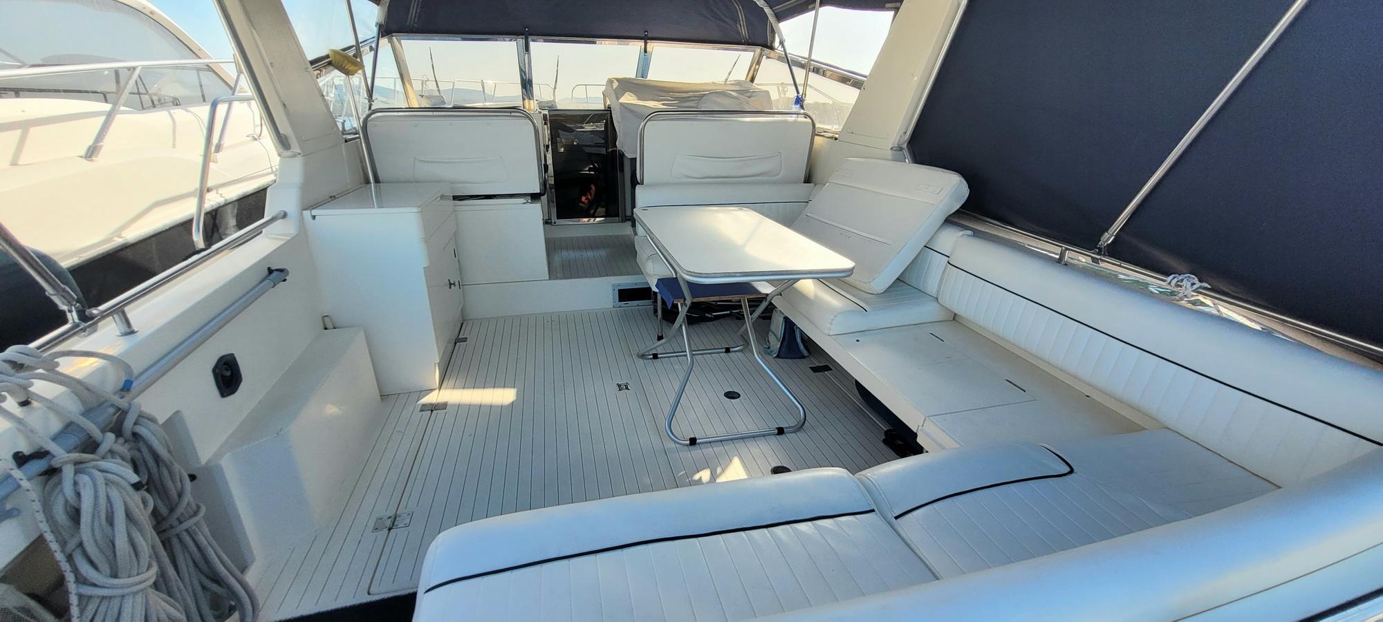 Marine Projects Princess Riviera 36 1990 Princess Riviera 36 yacht interior with white seating and table.