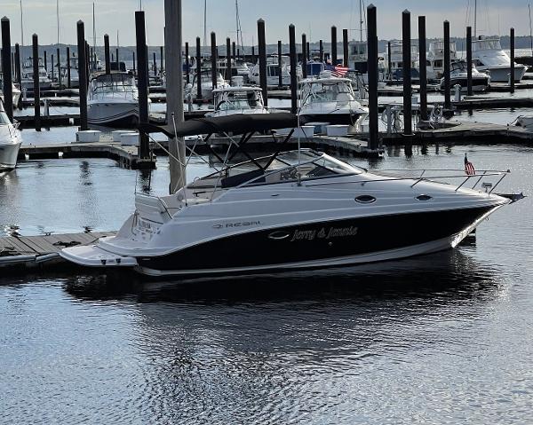 Regal 2700 Commodore 2010 Regal 2700 Commodore boat docked in a marina, surrounded by other vessels.
