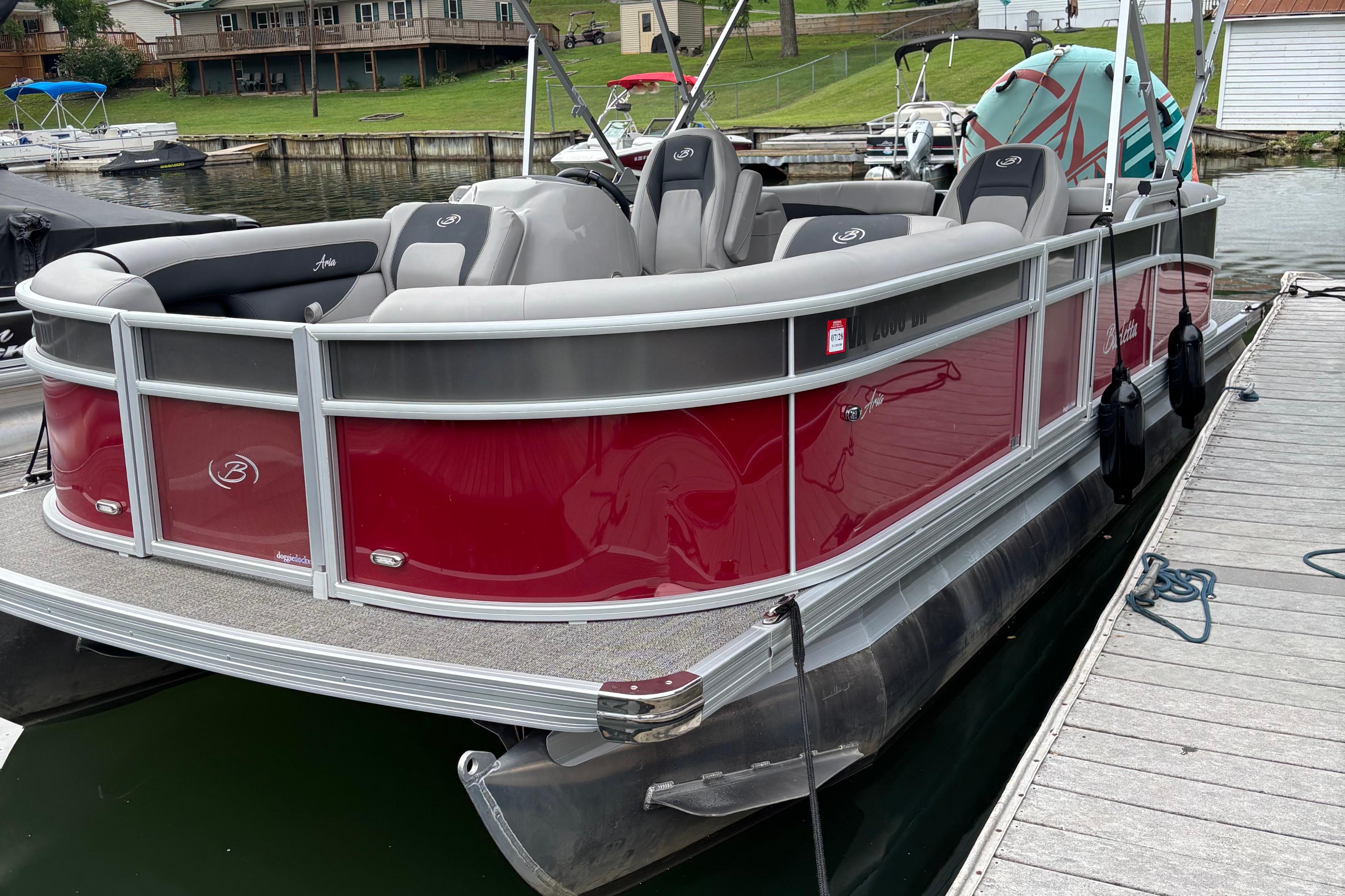 Barletta ARIA 22QC 2025 Barletta ARIA 22QC pontoon boat docked, featuring red and gray design.