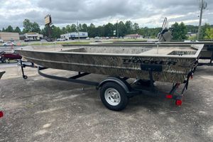 Tracker Grizzly 1860 Utility 2026 Tracker GRIZZLY 1860 Utility boat on trailer, camo design, parked outdoors.