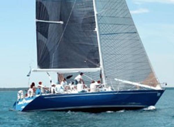Mull 54 1973 Mull 54 sailboat with crew sailing on open water.