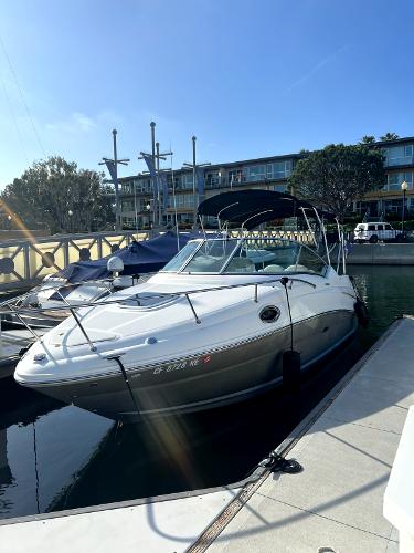 Sea Ray Sundancer 2005 Sea Ray Sundancer docked at a marina under clear blue skies.
