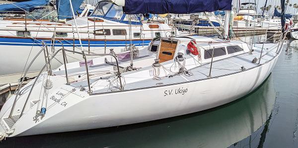 Soverel 33 1985 Soverel 33 sailboat docked in a marina, featuring sleek white design.