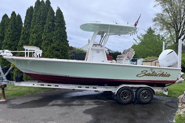Sportsman Masters 247 Bay Boat 2019 Sportsman Masters 247 Bay Boat on trailer, parked outdoors with trees in background.
