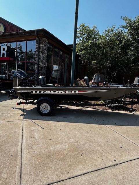 Tracker Panfish 17 2025 Tracker Panfish 17 boat on trailer, parked outside a building.