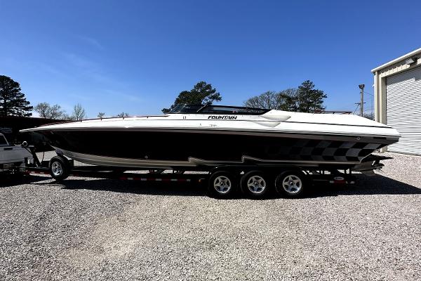 Fountain 38 Lightning 2003 Fountain 38 Lightning speedboat on a trailer in a gravel lot.