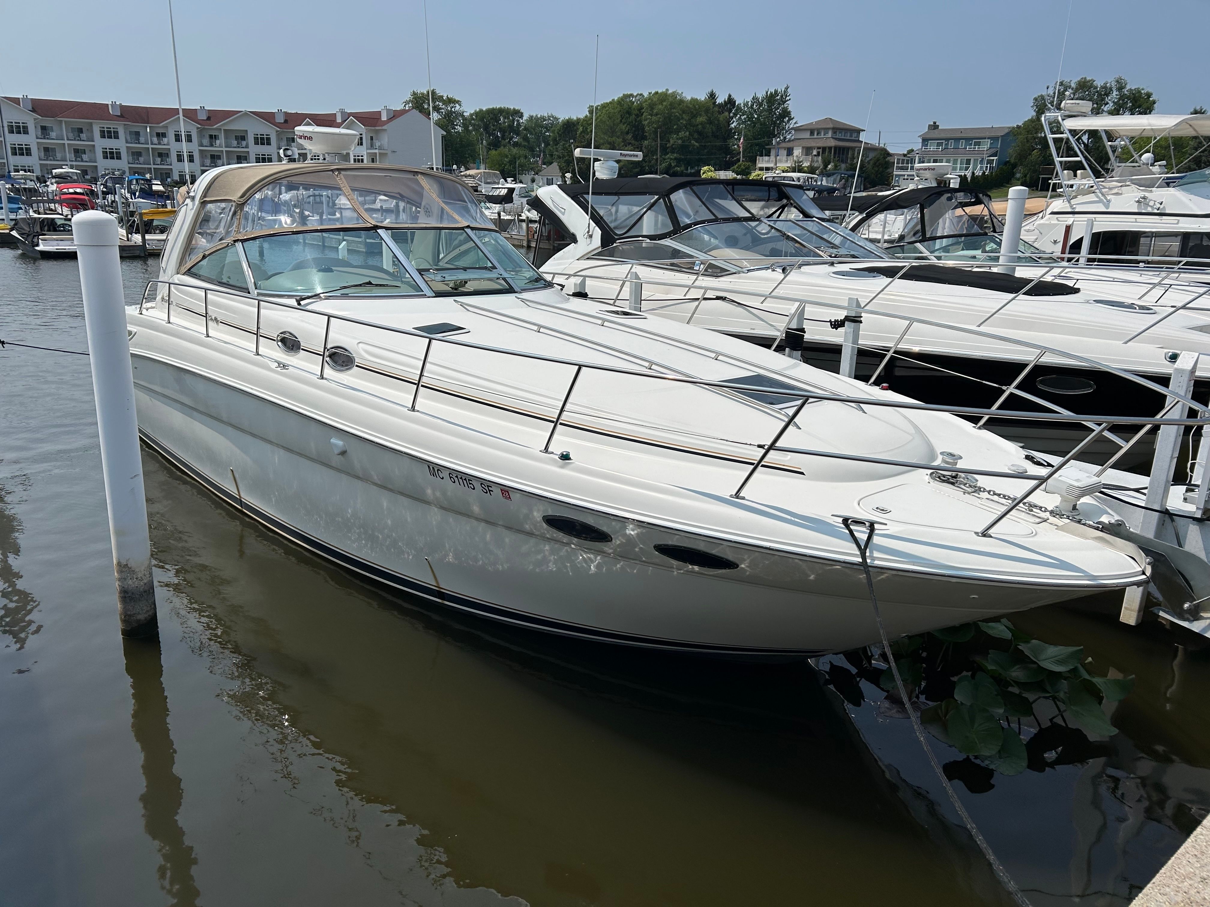 Sea Ray 380 Sundancer 2000 Sea Ray 380 Sundancer docked at marina, surrounded by other boats.
