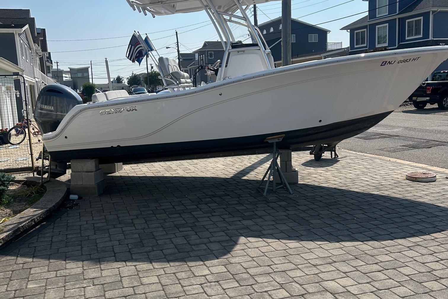 Sea Fox 228 Commander 2024 Sea Fox 228 Commander boat on blocks, parked on a paved driveway.