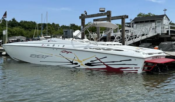 Baja 40 Outlaw 2000 Baja 40 Outlaw boat docked, featuring vibrant graphics and sleek design.