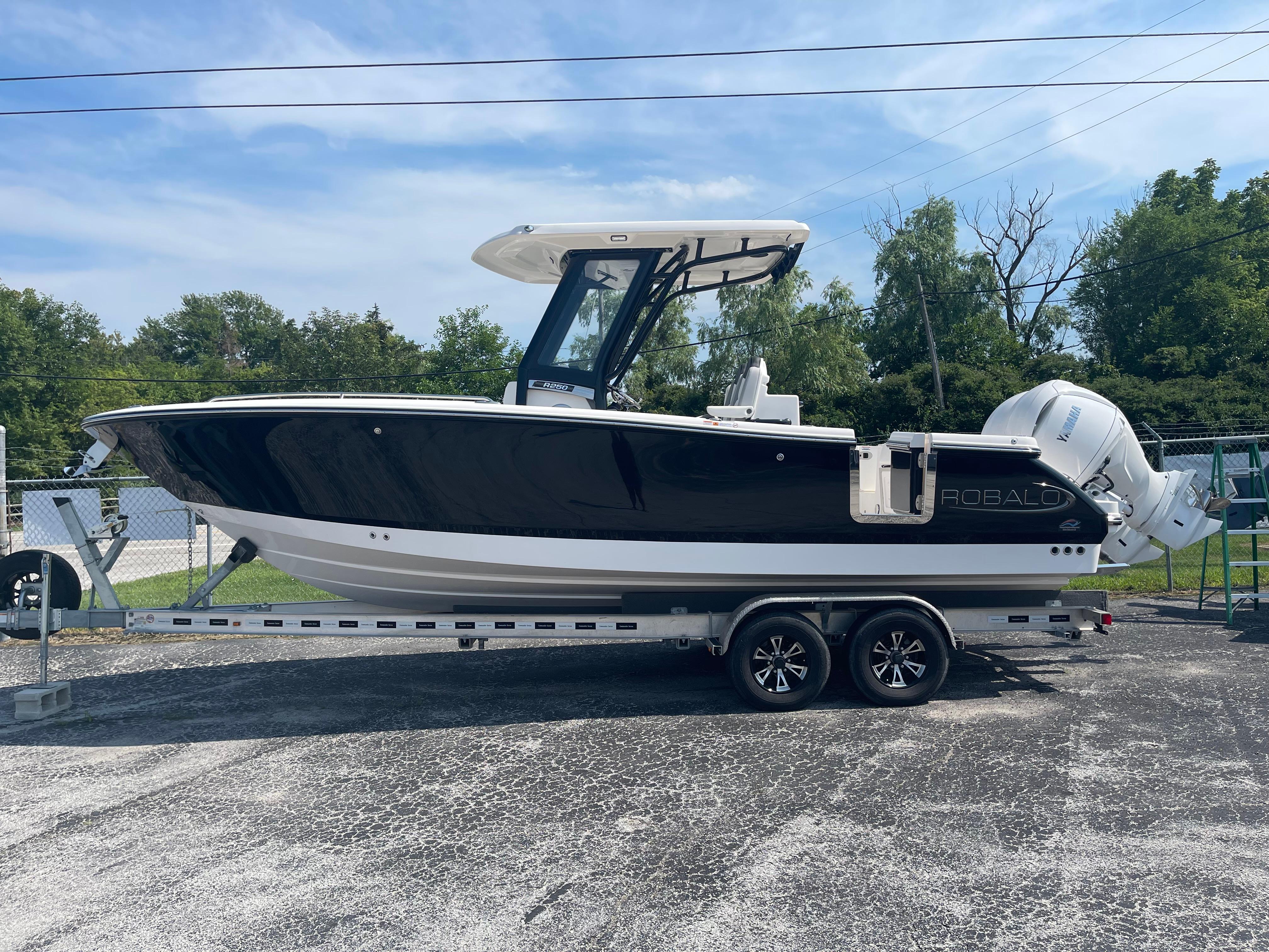 Robalo R250 Center Console 2025 Robalo R250 Center Console boat on trailer, parked outdoors.