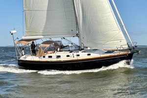 Tartan 3700 CCR 2007 Tartan 3700 CCR sailboat navigating ocean waves under full sail.