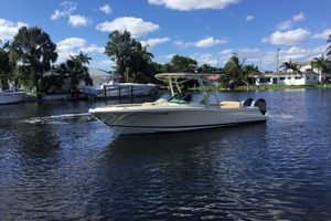 Chris-Craft Calypso 26 2016 Chris-Craft Calypso 26 boat cruising on a sunny day in a scenic waterway.