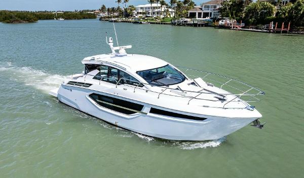 Cruisers Yachts 42 Cantius 2023 Cruisers Yachts 42 Cantius cruising on a serene waterway.