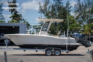Scout 215 XSF 2023 Scout 215 XSF boat on trailer, parked outdoors, side view.