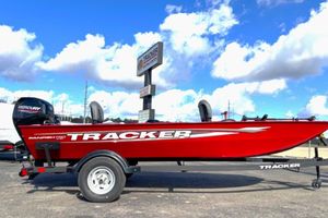 Tracker Panfish 17 2025 Tracker Panfish 17 boat, red exterior, on trailer under blue sky.