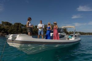 Capelli Tempest 40 Four people enjoying a day on a 2016 Capelli Tempest 40 boat in clear blue waters.