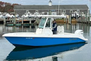 Everglades 235 Center Console 2023 Everglades 235 Center Console boat docked at a marina with a person onboard.