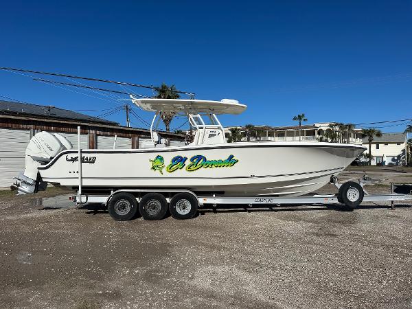 Mako 334 CC 2019 Mako 334 CC boat on trailer, side view, outdoors, clear sky.