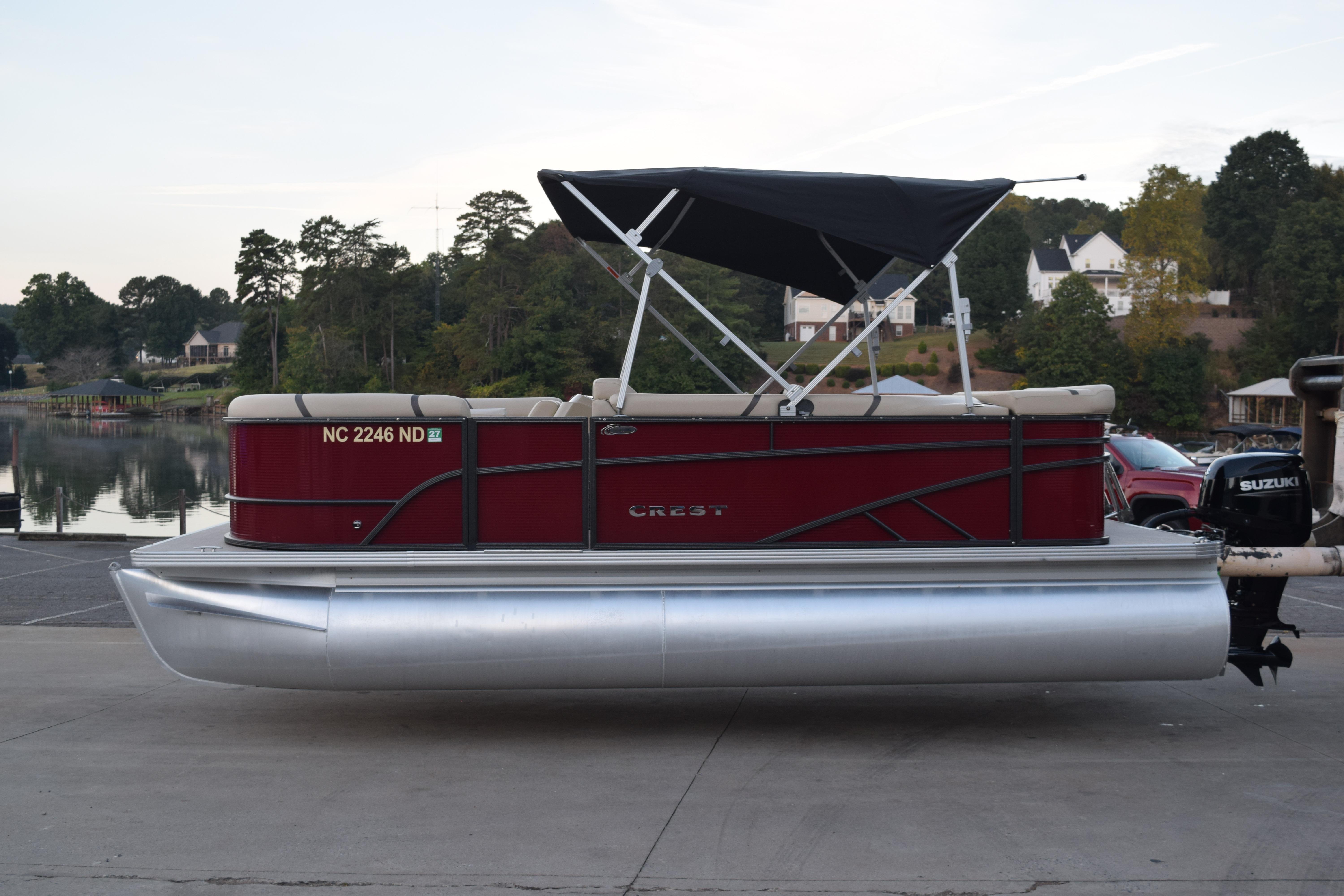 Crest Classic LX 200 L 2024 Crest Classic LX 200 L pontoon boat docked by a serene lakeside.