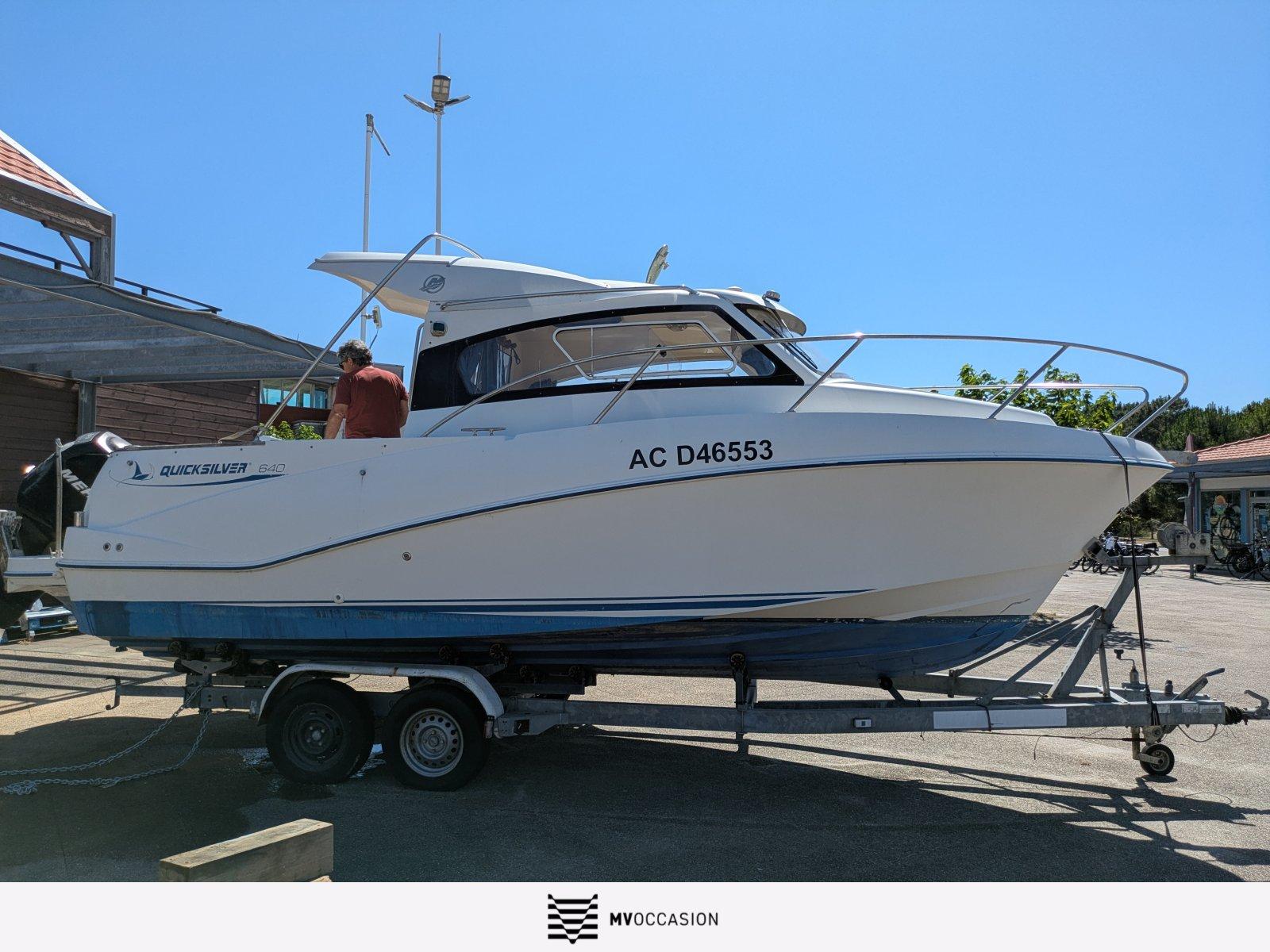 Quicksilver 640 Weekend OB 2007 Quicksilver 640 Weekend OB boat on trailer under clear blue sky.