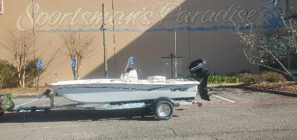 Mako Pro Skiff 15 CC 2025 Mako Pro Skiff 15 CC boat on trailer in parking lot.