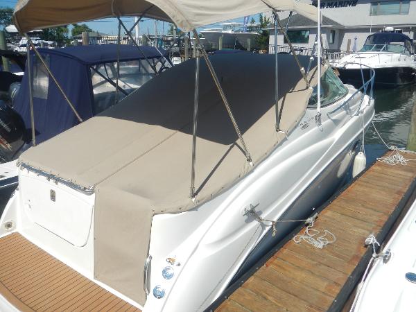 Maxum 2500 SCR 2001 Maxum 2500 SCR boat docked with beige cover and canopy.