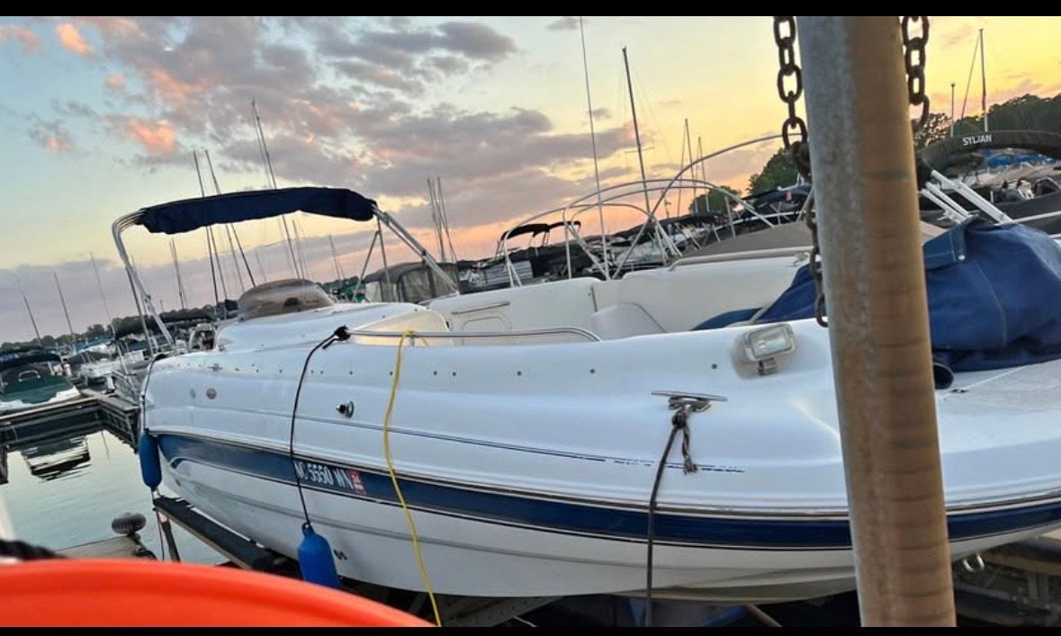 Chaparral Sunesta 252 2000 Chaparral Sunesta 252 boat docked at sunset with a scenic marina backdrop.