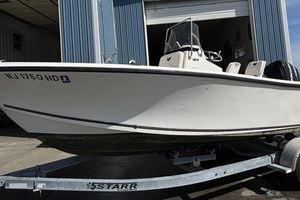 Mako 184 Center Console 2010 Mako 184 Center Console boat on trailer outside a blue building.