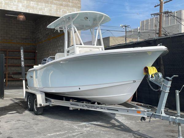 Sea Hunt Ultrta 219 2021 Sea Hunt Ultra 219 boat on trailer in urban setting.