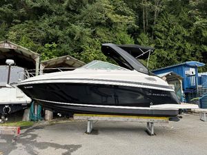 Regal 28 Express 2015 Regal 28 Express boat on a stand, surrounded by trees and buildings.