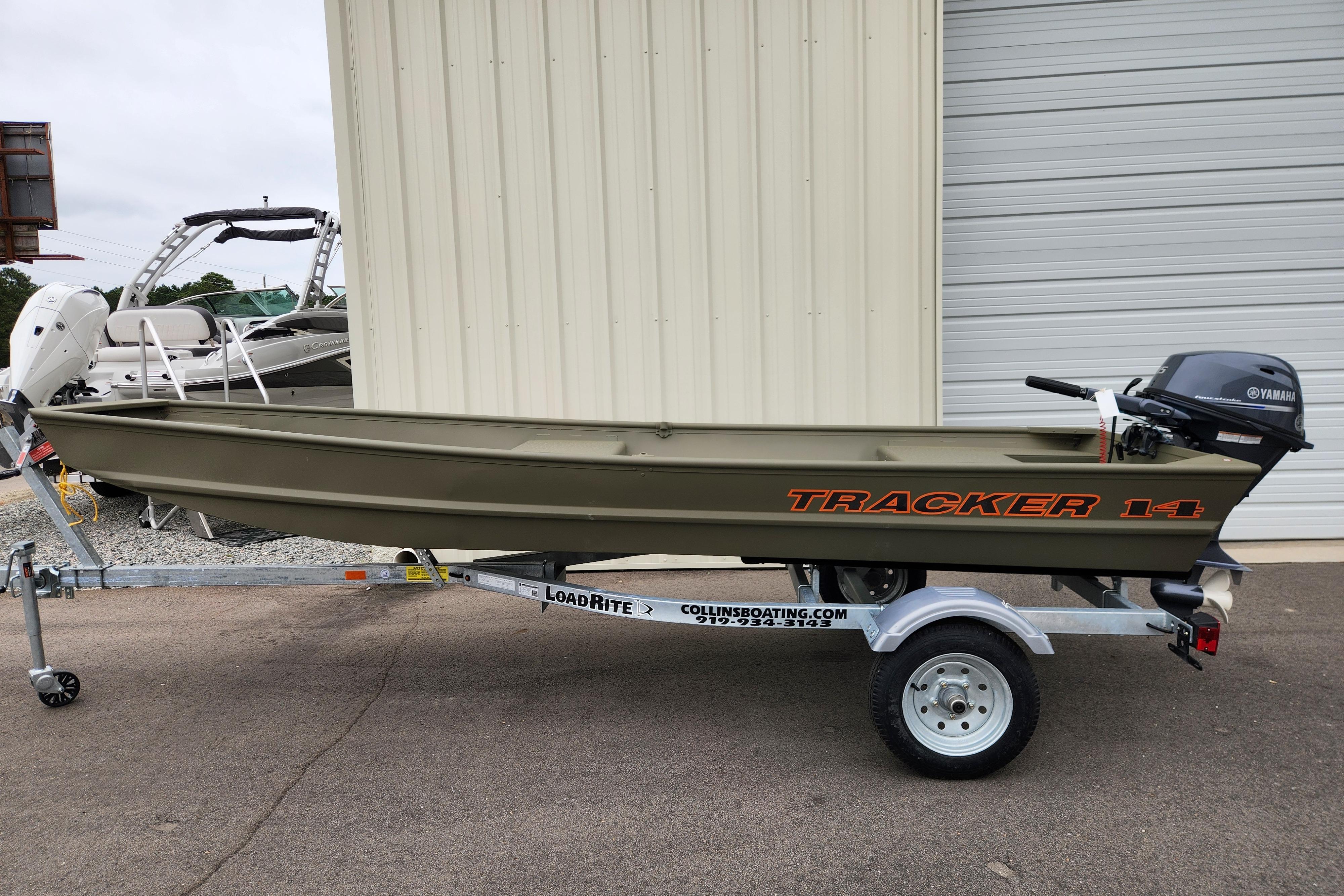 Tracker Grizzly 1436 Utility 2026 Tracker Grizzly 1436 Utility boat on Load Rite trailer, parked outdoors.