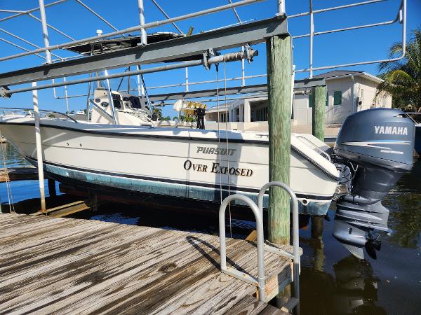 Pursuit 2470 Center Console 2004 Pursuit 2470 Center Console boat on lift with Yamaha outboard motor.