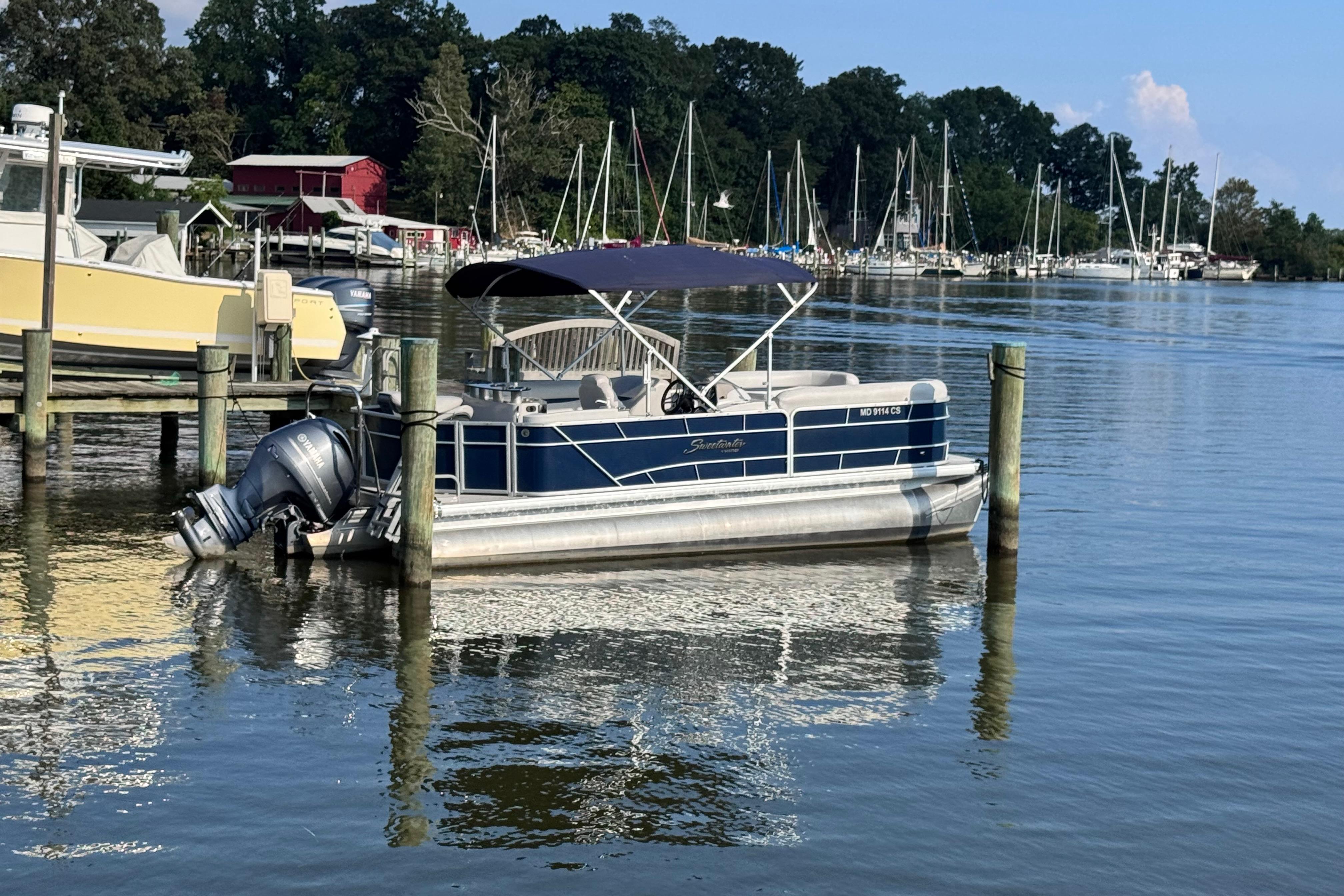 Sweetwater 2286 WB 2018 Sweetwater 2286 WB pontoon boat docked in a serene marina setting.