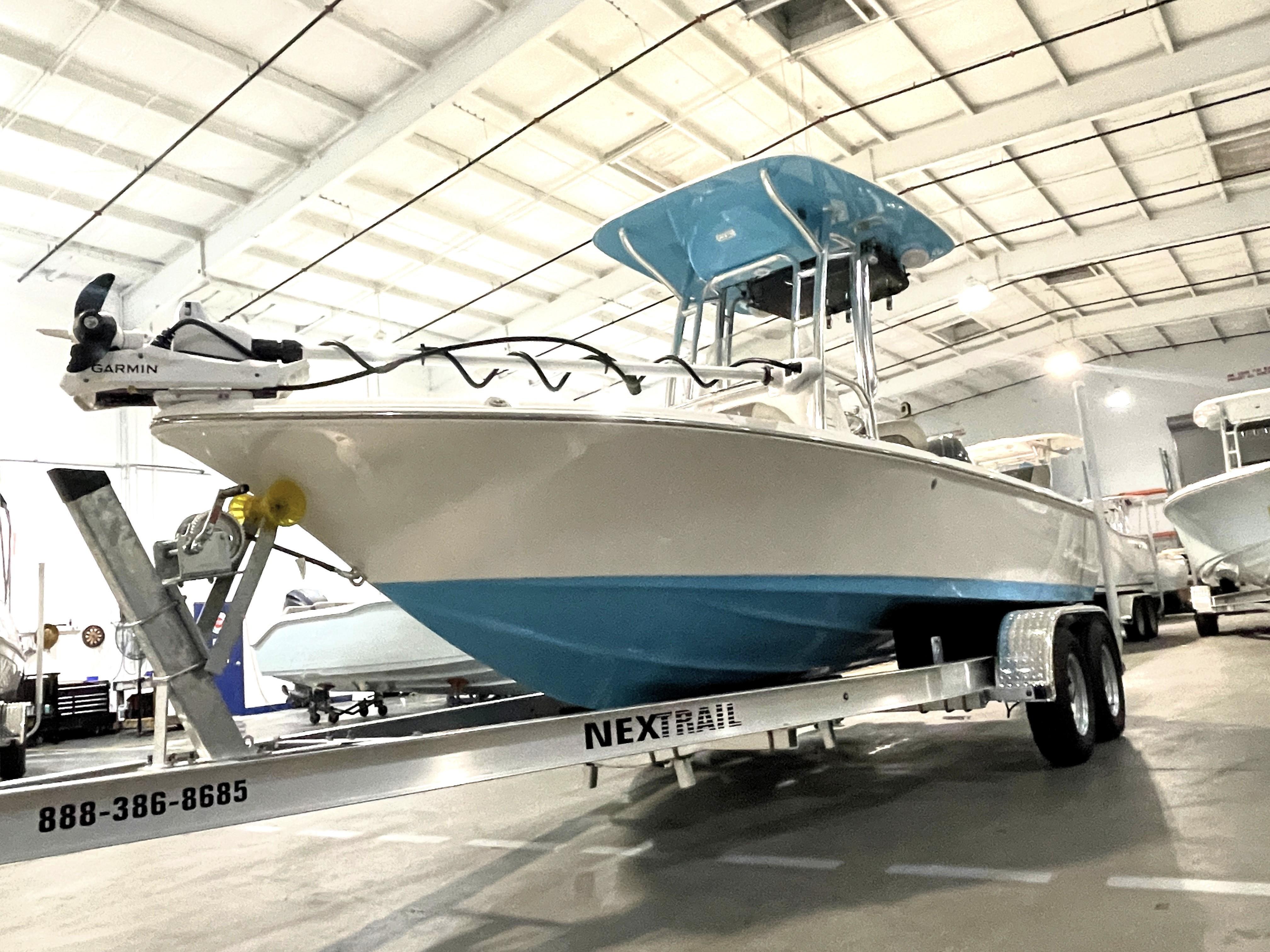 Key West 210 Bay Reef 2025 Key West 210 Bay Reef boat on trailer in indoor showroom.