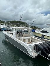 Boston Whaler 420 Outrage 2015 Boston Whaler 420 Outrage boat docked in a marina under cloudy skies.