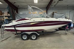 Hurricane SunDeck 2400 IO 2008 Hurricane SunDeck 2400 IO boat on trailer in indoor storage facility.