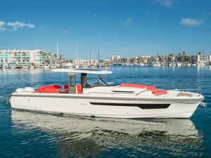 Nimbus T11 2021 Nimbus T11 boat cruising in a marina with clear blue skies.