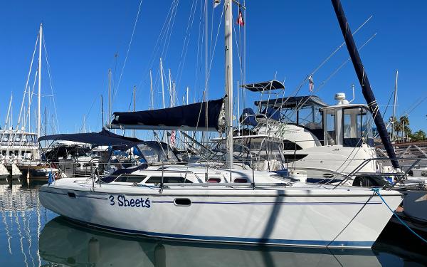 Catalina 320 Catalina 320 sailboat from 2001 docked in a marina under clear blue skies.