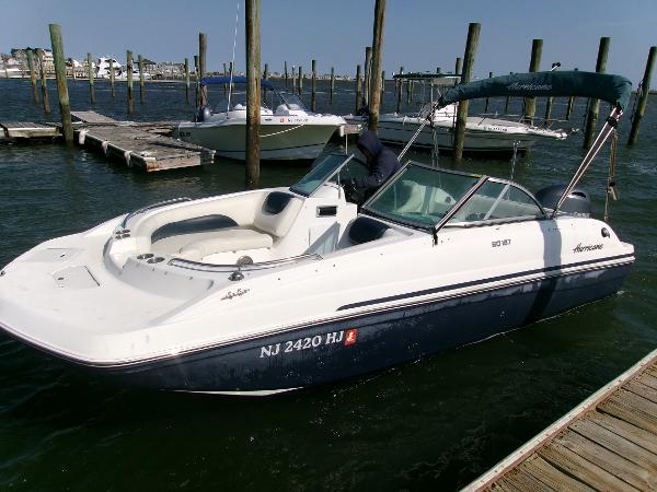 Hurricane SunDeck 187 OB 2016 Hurricane SunDeck 187 OB boat docked in marina, featuring sleek design and spacious seating.