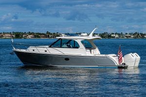 Hinckley 40x 2023 Hinckley 40x yacht cruising on a sunny day with a scenic coastal backdrop.