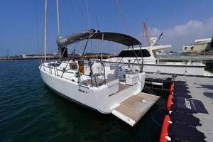 Elan E4 2022 Elan E4 sailboat docked at marina, featuring sleek design and spacious deck.