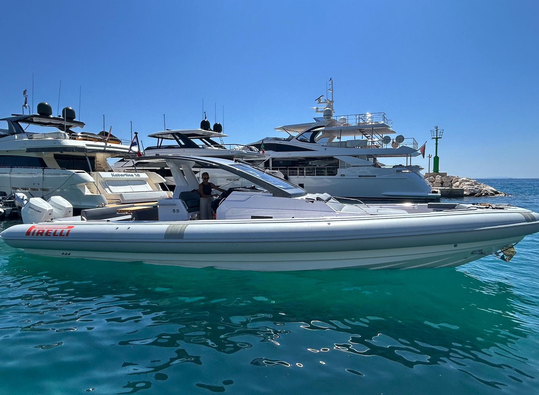Pirelli 42 Pirelli 42 yacht, 2025 model, docked in a marina with clear blue water.