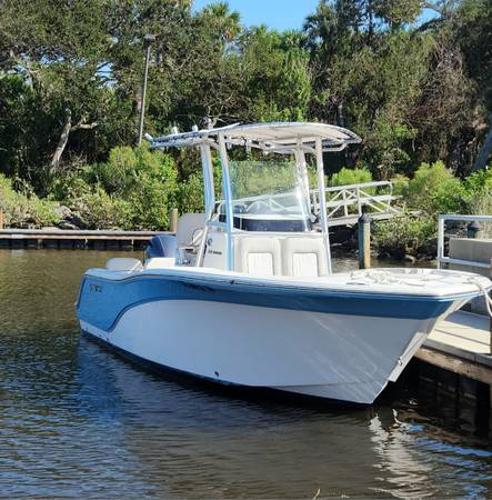 Sea Fox 228 Commander 2022 Sea Fox 228 Commander boat docked by a lush, green shoreline.