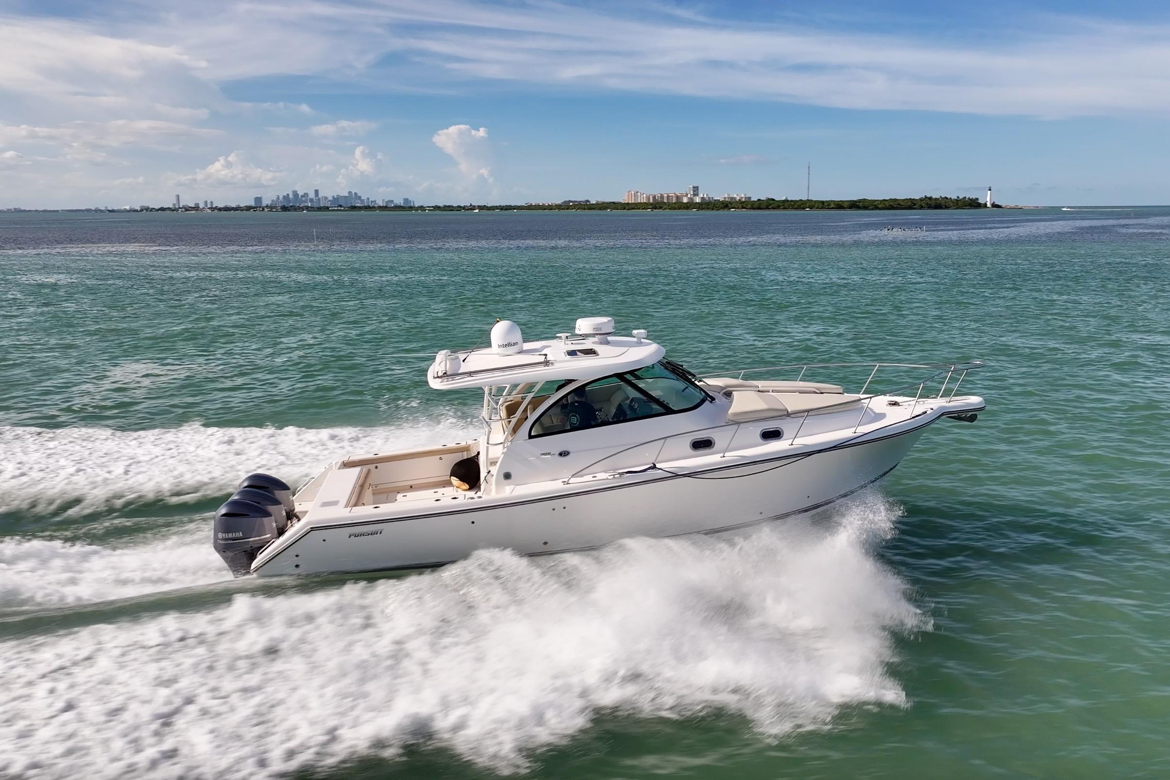 Pursuit OS 385 Offshore 2016 Pursuit OS 385 Offshore cruising on open water, city skyline in background.