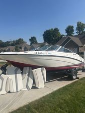 Yamaha Boats SX190 2018 Yamaha Boats SX190 on trailer with seat cushions, parked in residential area.
